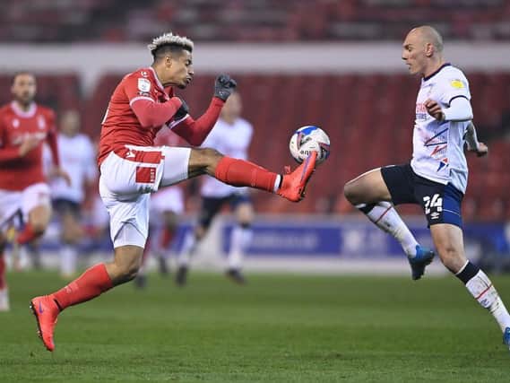 Kal Naismith makes a challenge on Nottingham Forest substitute Lyle Taylor