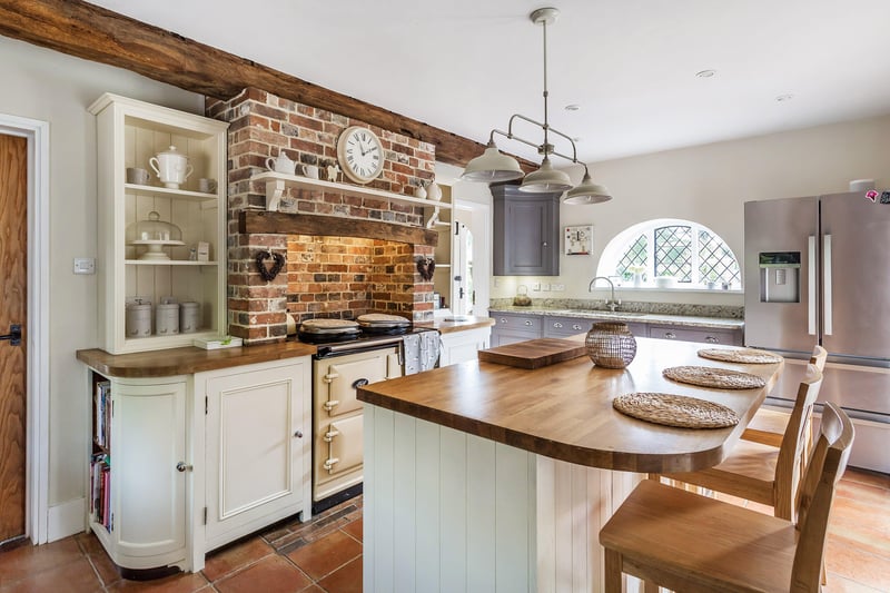 The kitchen has a country style feel and has a range of solid wood units with a mix of granite and oak work tops.