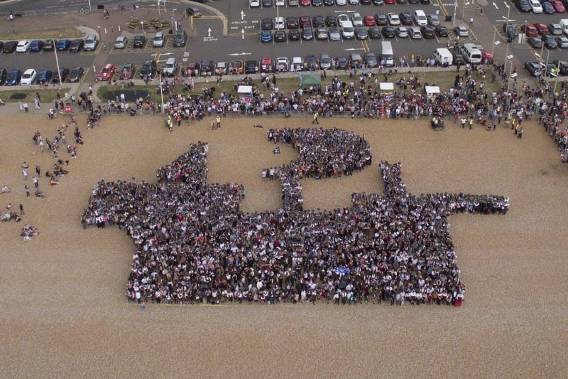More than 3,500 people gathered to create a pirate ship on Pelham Beach. Picture by Paul Gibson SUS-190717-092933001