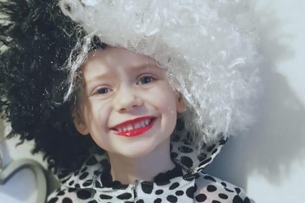 Kionie, aged 4, has spent all morning transforming into Cruella Deville with trademark red lipstick and black and white curly hair.