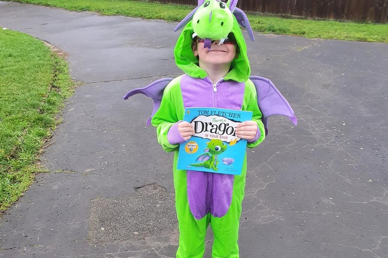 Smiley Finley Cullum has dressed up as the dragon from 'There's A Dragon In My Book'.