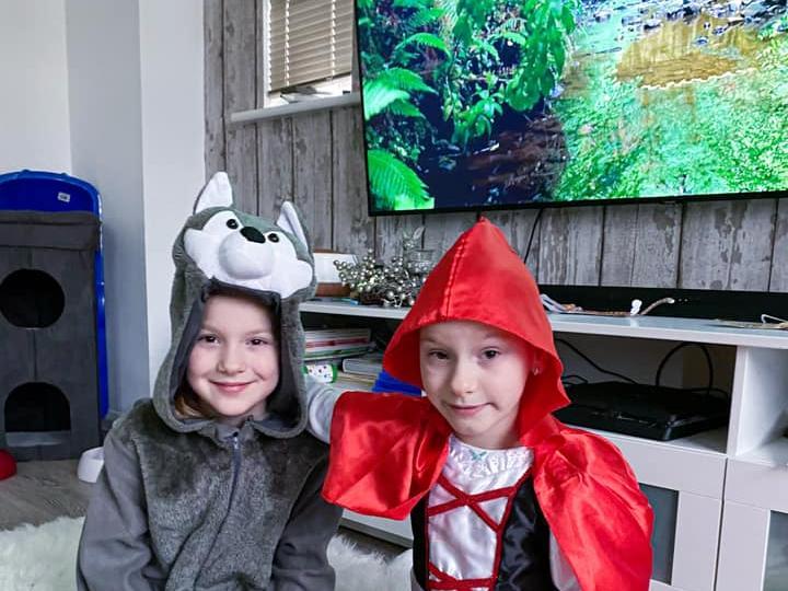 These twin sisters, Adriana and Annelia, 7, have dressed up today as Little Red Riding Hood and the Big Bad Wolf.