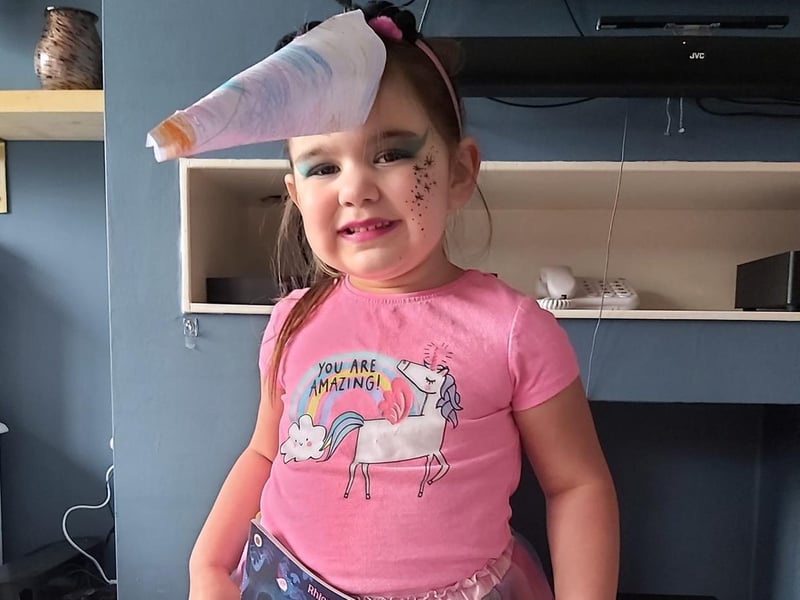 Hallie is dressed up as Twinkle the Unicorn from Ten Minutes To Bed Little Unicorn.