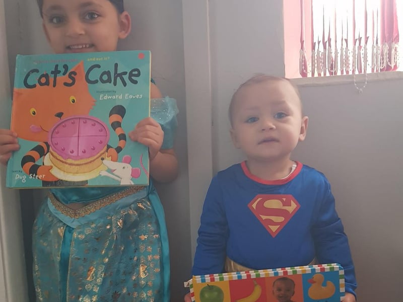 Esme Lowe, 4, and Rudy Thomas, 18 months old, are all dressed up for today.