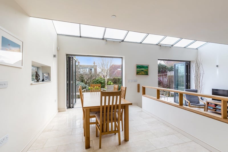 Bifold doors in the open plan dining room leads out in to the garden, bringing the outside in.