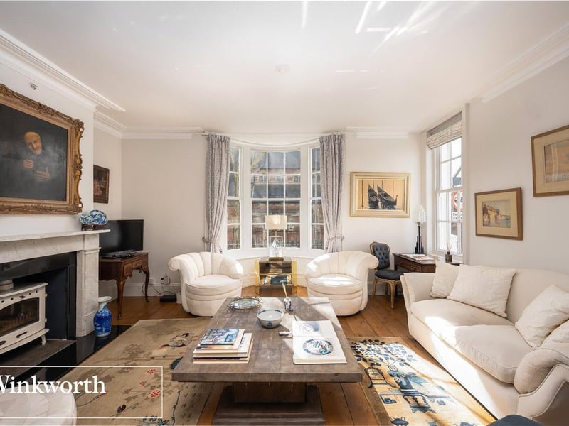 The sitting room is ideal for entertaining and boasts a marble fire place and log burning stove.