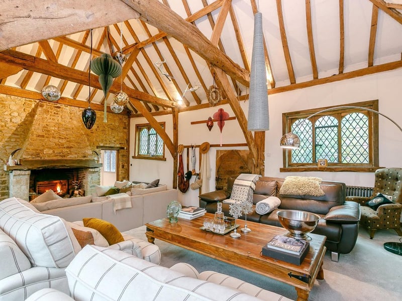 Newer portion of the property to the late 1500s barn; which is now a split level drawing room with exposed timbers, beams and stonework.