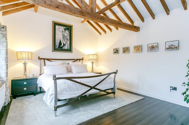 The master bedroom boasts a vaulted ceiling, en suite shower with slate floor and views onto the courtyard garden.