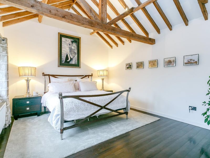The master bedroom boasts a vaulted ceiling, en suite shower with slate floor and views onto the courtyard garden.