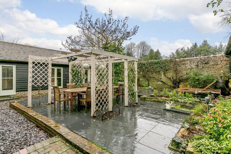 The enclosed, walled courtyard garden has an attractive brick and stone paved design with central pagoda and climbing Jasmine; providing the perfect location for outside entertaining.