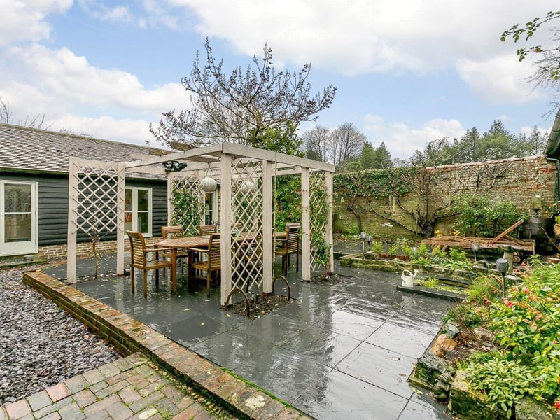 The enclosed, walled courtyard garden has an attractive brick and stone paved design with central pagoda and climbing Jasmine; providing the perfect location for outside entertaining.