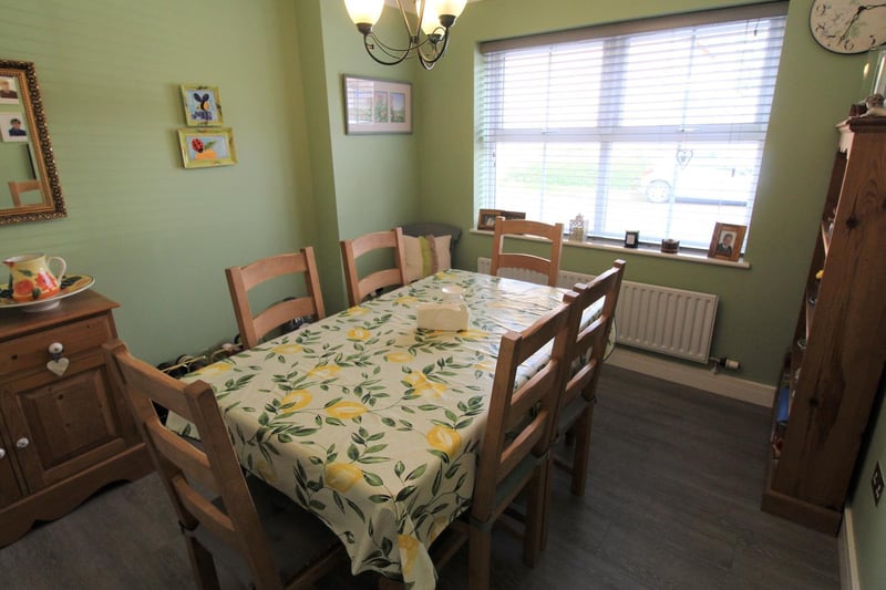 A dining room with uPVC double glazed windows to front. Radiator. Coving to ceiling. Composite laminate flooring.