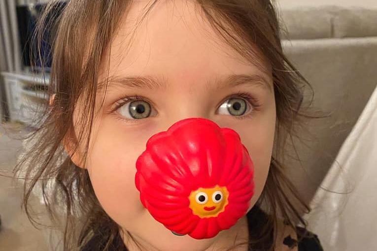 Mia, 4, wearing her red nose for Comic Relief. "Problem is, she wants a golden Tommy one so I feel like I have to buy hundreds of boxes and employ a factory of people like Veruca Salt's dad (Charlie and the chocolate factory) to find the golden Tommy!"