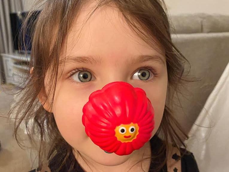 Mia, 4, wearing her red nose for Comic Relief. "Problem is, she wants a golden Tommy one so I feel like I have to buy hundreds of boxes and employ a factory of people like Veruca Salt's dad (Charlie and the chocolate factory) to find the golden Tommy!"