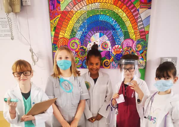 Students with their NHS rainbow artwork