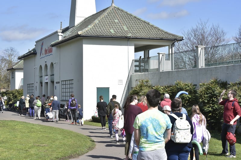 A large queue of people wait to get in an The Lido.