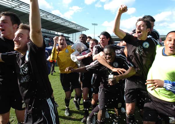 Posh players celebrate promotion from League One in 2009.