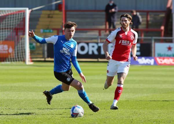 Harrison Burrows of Peterborough United in action with Wes Burns of Fleetwood Town. Photo: Joe Dent/theposh.com.