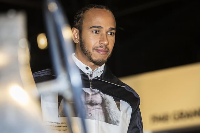 Lewis Hamilton checks out one of the vintage cars on display at The Silverstone Experience