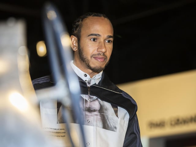 Lewis Hamilton checks out one of the vintage cars on display at The Silverstone Experience