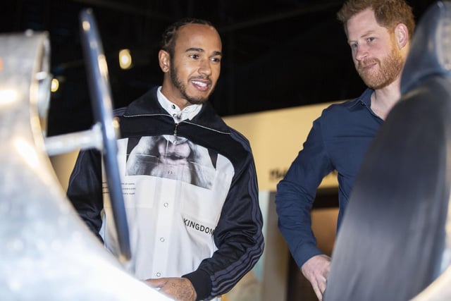 Prince Harry and Lewis Hamilton check out one of the vintage cars on display at The Silverstone Experience