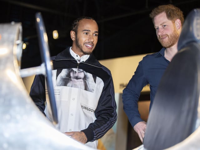 Prince Harry and Lewis Hamilton check out one of the vintage cars on display at The Silverstone Experience