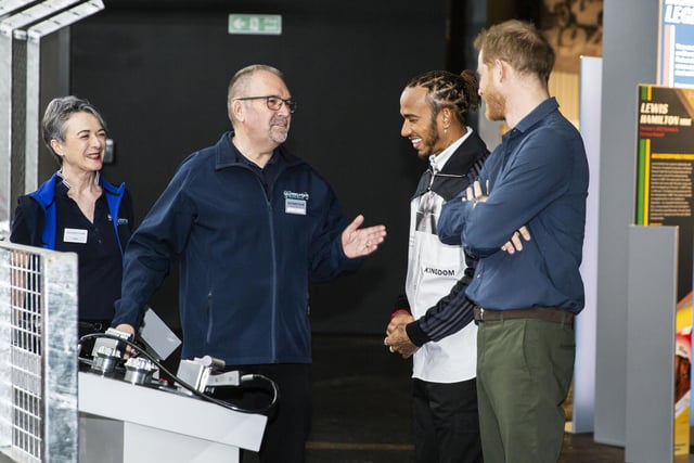 Prince Harry and Lewis Hamilton hear about the tyre-changing game at The Silverstone Experience