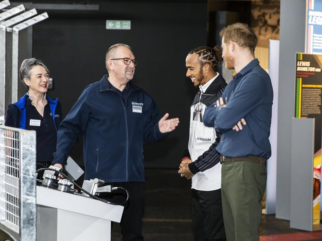 Prince Harry and Lewis Hamilton hear about the tyre-changing game at The Silverstone Experience