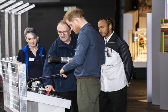Prince Harry has a go at the tyre-changing game at The Silverstone Experience