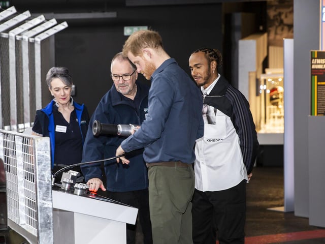 Prince Harry has a go at the tyre-changing game at The Silverstone Experience