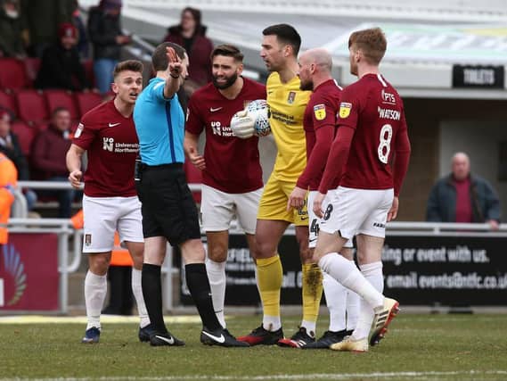 Sam Hoskins is directed off the pitch by Peter Wright despite protests. Pictures: Pete Norton