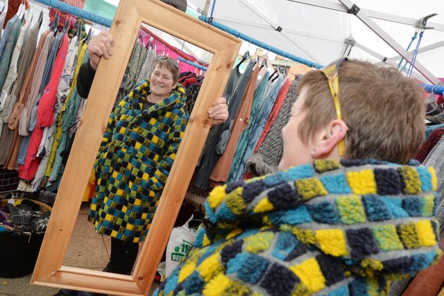 Claire Devlin tries on a coat at the international market.
PICTURE: ANDREW CARPENTER
