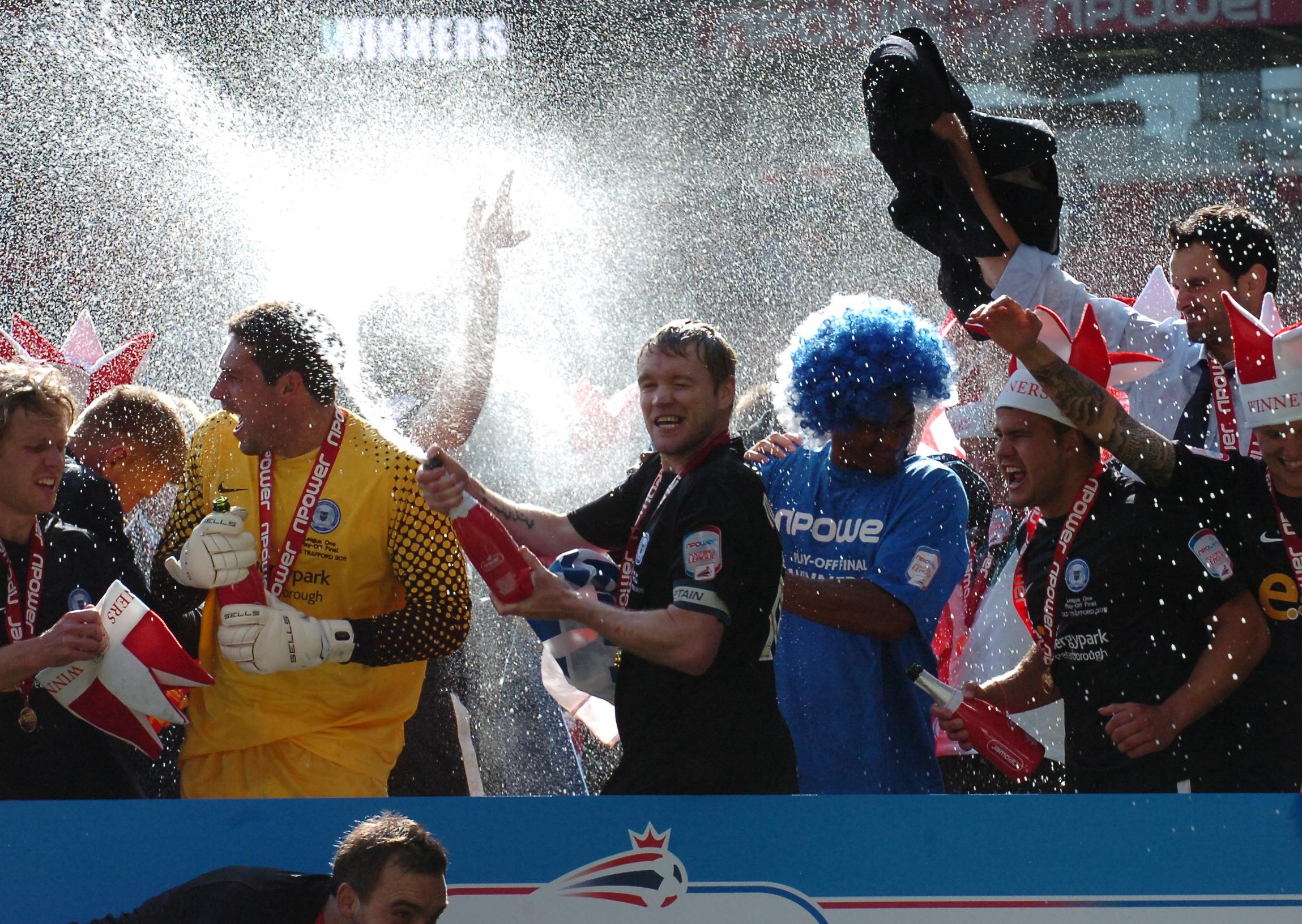 Posh players celebrate their play-off final win at Old Trafford.