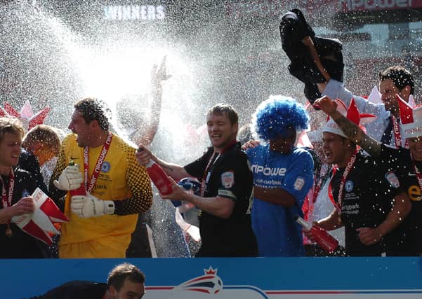 Posh players celebrate their play-off final win at Old Trafford.