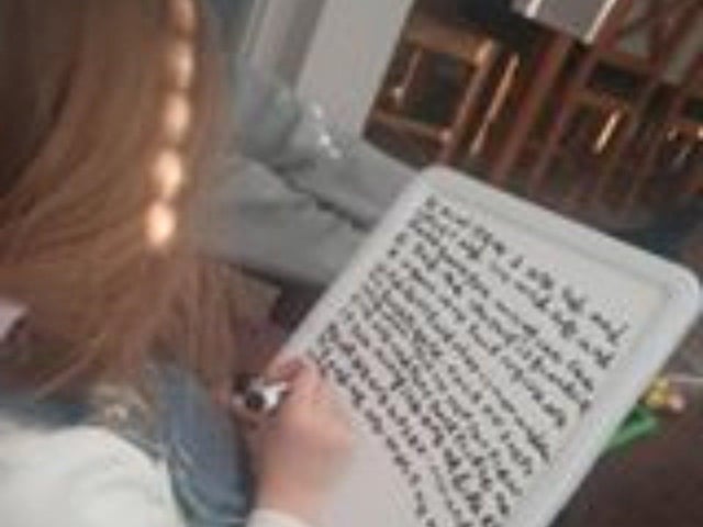 Ava, aged 5, taking notes on her whiteboard. Photo courtsey of Lauren Middleton
