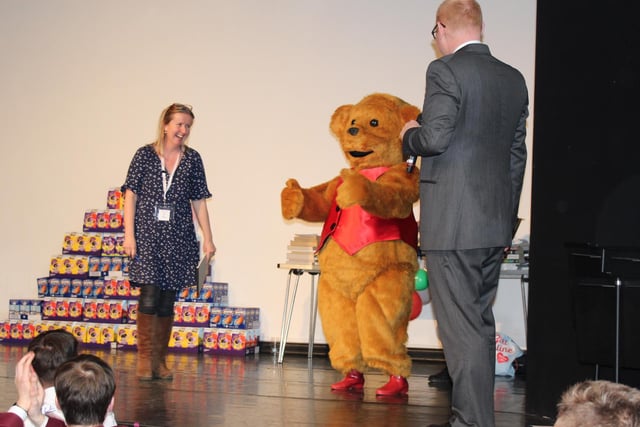 A local magician performed and a parent with a teddy bear mascot came to applaud the children as they collected their gifts.