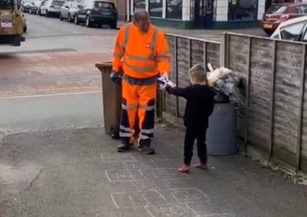 Five-year-old Buddy Strudwick thanking a hard-working dustman in Bognor by giving him an Easter egg