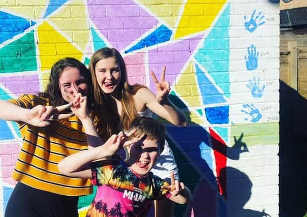 Alisia, Eva and Zac paint their garage with colourful designs