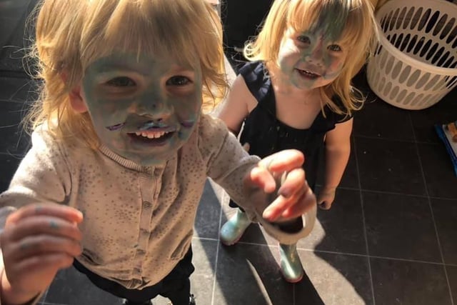 Lily (4) and Ellie (2) painted the floor outside and then their faces