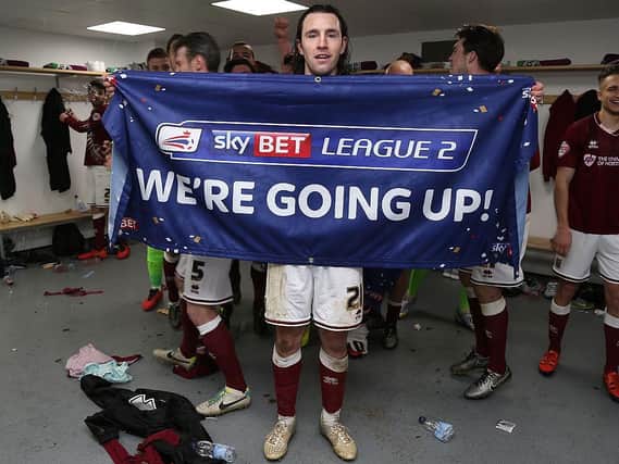 John-Joe O'Toole celebrates in the dressing room after Cobblers' 2-2 draw with Bristol Rovers.