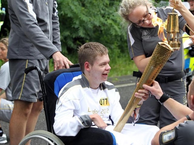Luke Somerville from Northampton takes the torch in Geddington