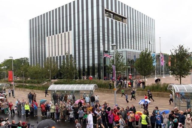 The torch makes its way past the Corby Cube