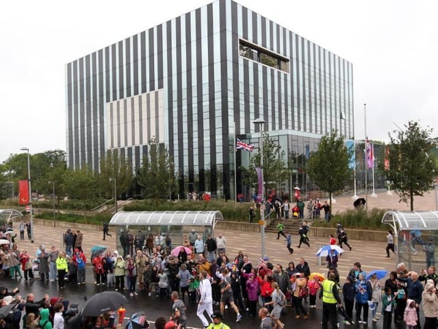 The torch makes its way past the Corby Cube