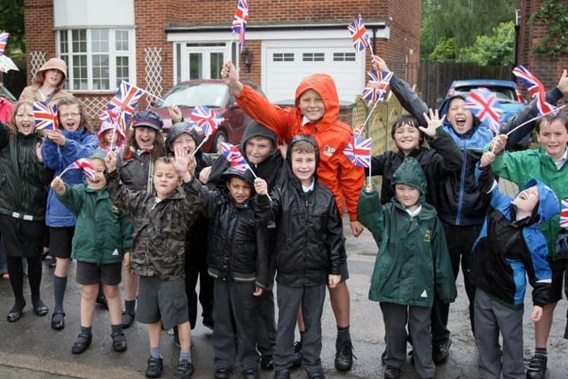 Hawthorn Primary School pupils brave the rain as they wait for the torch