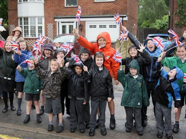 Hawthorn Primary School pupils brave the rain as they wait for the torch