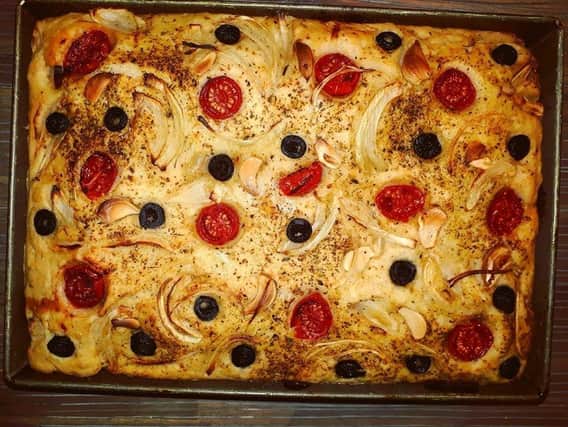 Sylvi Santamaria made foccacia bread with cherry tomatoes, olives, garlic and onions SUS-200414-151302001
