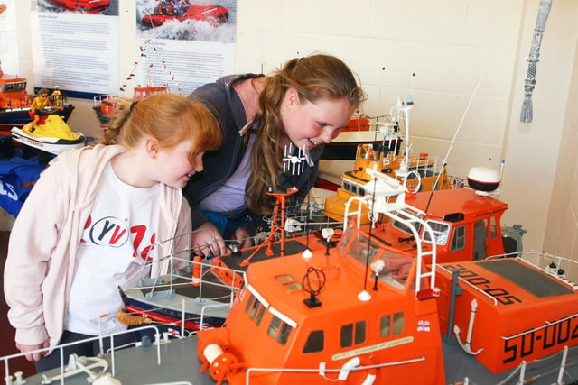 Sophie Greer, nine, and sister Hannah, 12, looking at the model lifeboats. Photo by Derek Martin DM1984042a