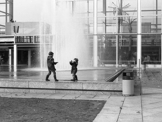 Two children enjoying the fountains
