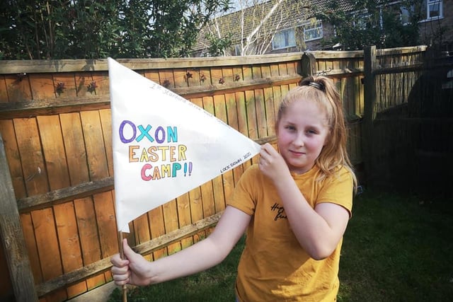 A scout holds a flag during the Oxfordshire wide virtual camp over the Easter holiday weekend