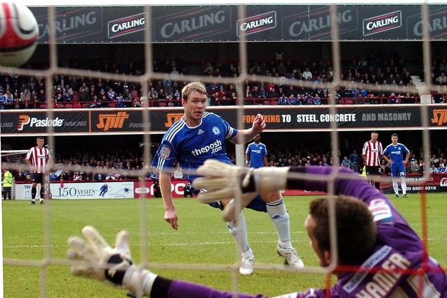 "A shot from behind the goal as Grant McCann scored a penalty for Posh against Brentford."